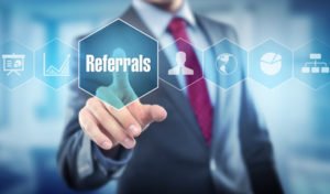 Image of a business man in a suit with a Referral graphic in the foreground. Core Alliance Management takes referrals.